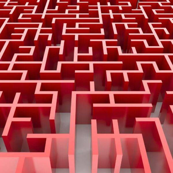 A red maze symbolizing the complexity of obtaining an adverse credit mortgage in the UK, and the journey toward homeownership