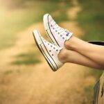 Person relaxing with feet out of car window on a sunny road trip - Car Finance Guide in the UK