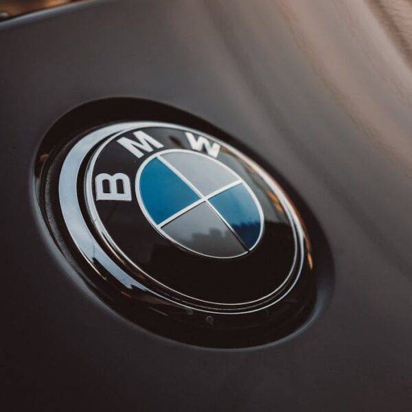 Close-up of BMW logo on a car hood representing a comparison between PCP, HP, and Auto Leasing options in the UK