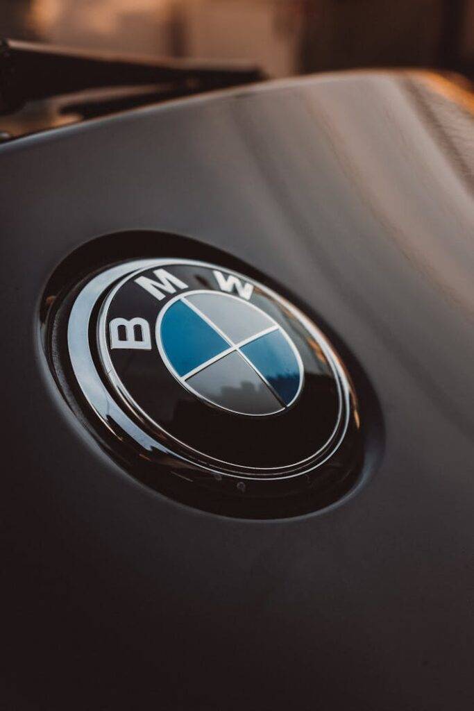 Close-up of BMW logo on a car hood representing a comparison between PCP, HP, and Auto Leasing options in the UK