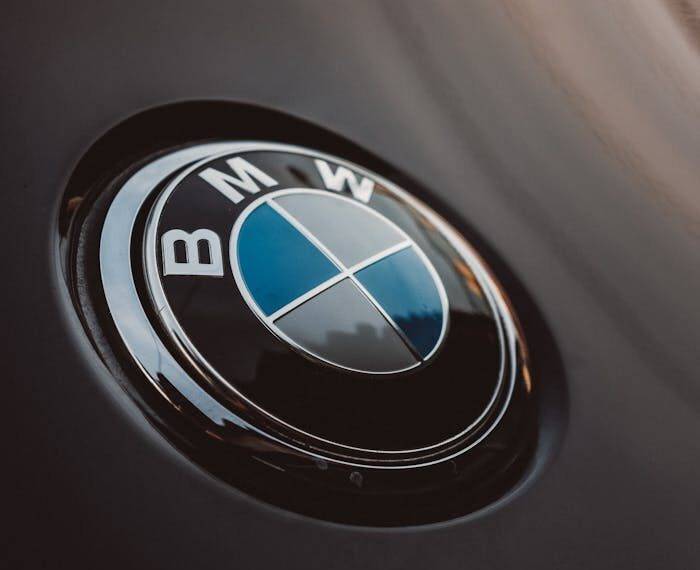 Close-up of BMW logo on a car hood representing a comparison between PCP, HP, and Auto Leasing options in the UK