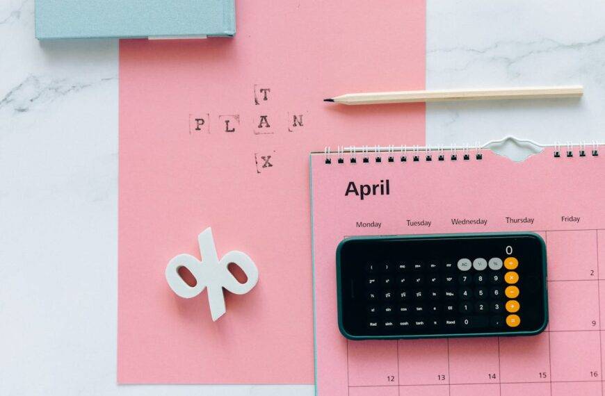 Calculator on a pink calendar with the word "Plan" written above, symbolizing the regulation of Buy Now Pay Later services in the UK and a new chapter in consumer credit