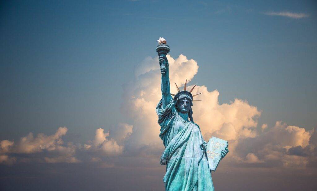 Statue of Liberty against a cloudy sky, symbolizing the escalating student loan debt crisis in the United States