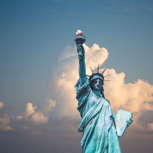 Statue of Liberty against a cloudy sky, symbolizing the escalating student loan debt crisis in the United States