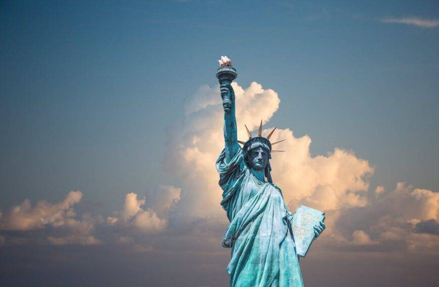 Statue of Liberty against a cloudy sky, symbolizing the escalating student loan debt crisis in the United States