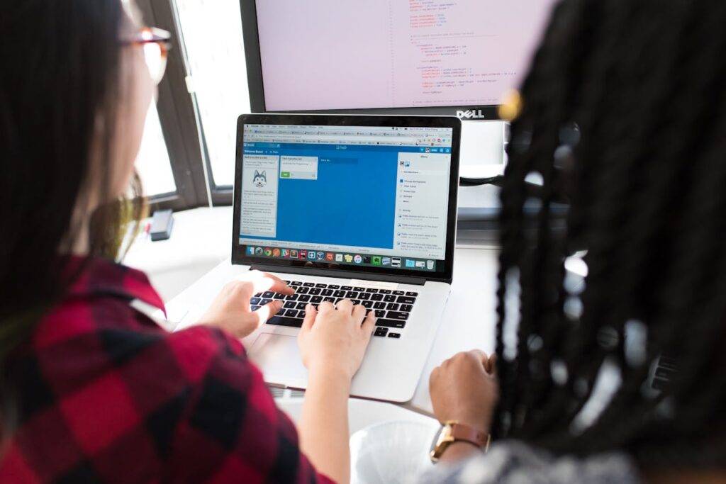 Two people working on a laptop, representing the top 10 data science and analytics online courses in 2024