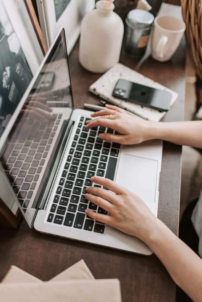 Person typing on a laptop, representing online learning from top elite schools on edX, offering Ivy League education at an affordable cost