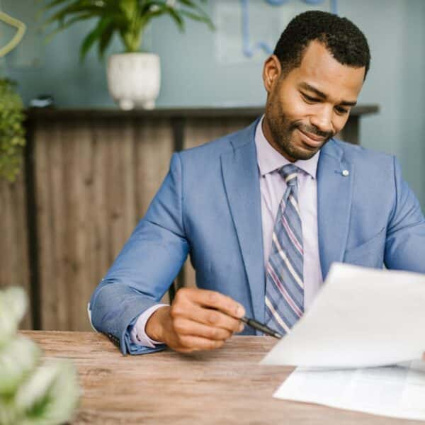 Smiling professional reviewing documents at a desk, representing the role of mortgage brokers in the UK