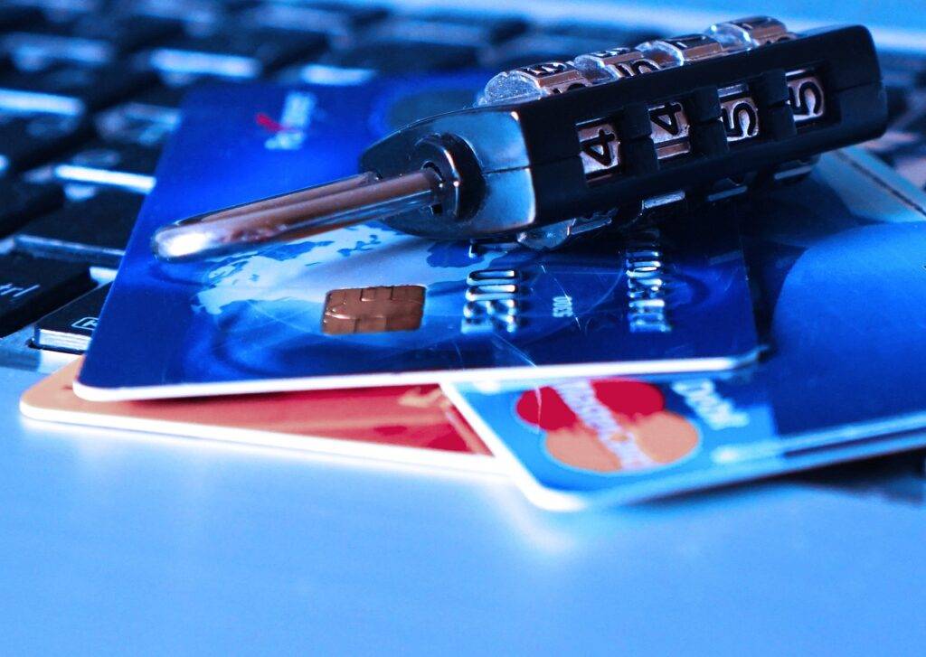 Close-up of credit cards with a combination lock, symbolizing security and the acceptance challenges of American Express in UK stores