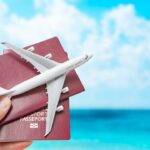 A hand holding passports and a toy airplane against a blue sky, symbolizing travel rewards and maximizing Avios points value