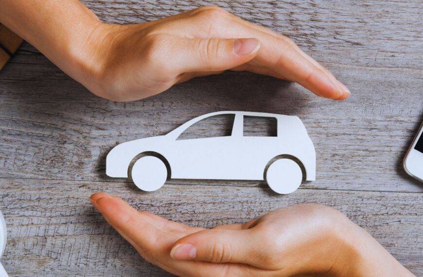 Hands protecting a car model representing car insurance and premium variations