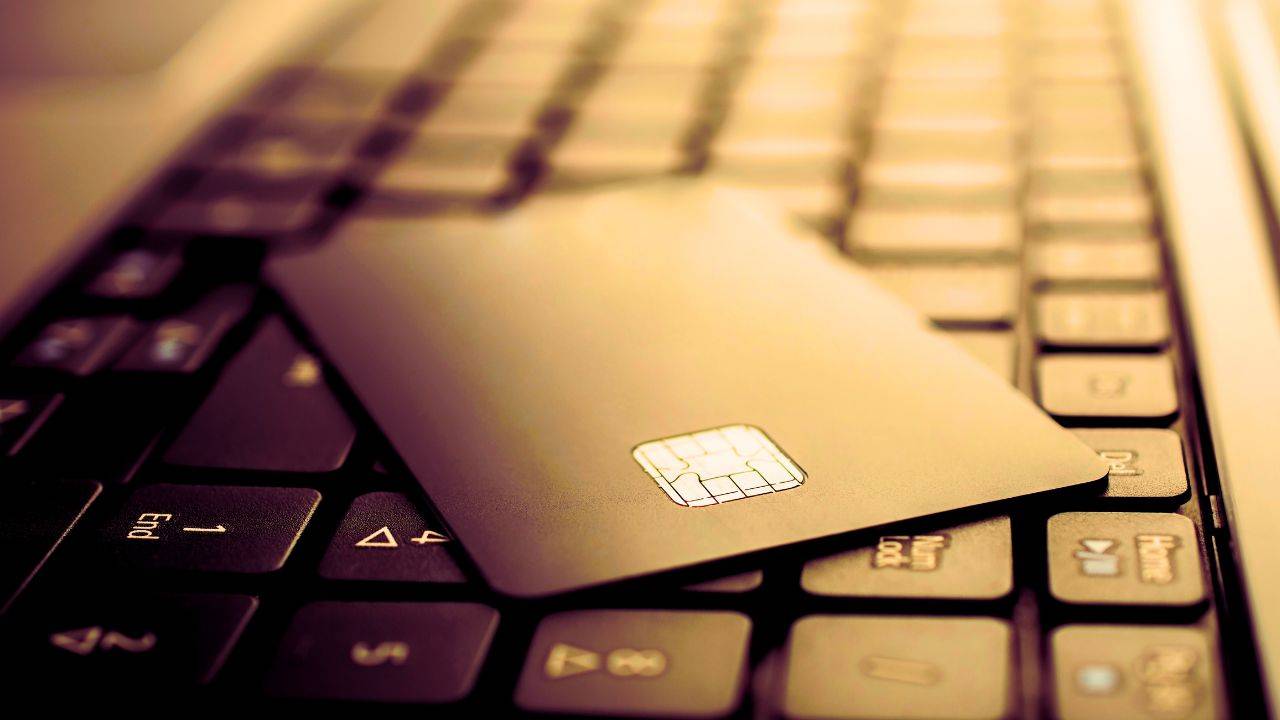 Close-up of a credit card on a laptop keyboard symbolizing online business transactions with a business credit card.