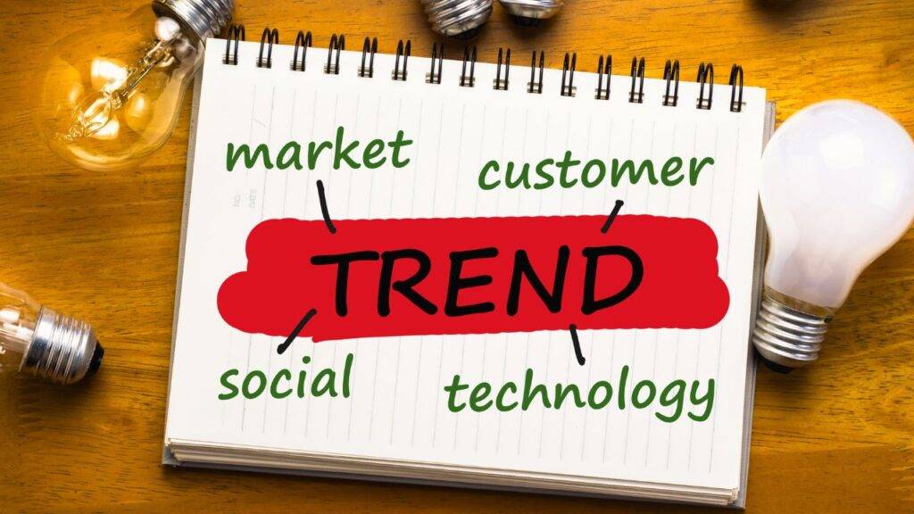 A notepad with the word "Trend" and key factors like market, customer, social, and technology, representing job trends for 2030