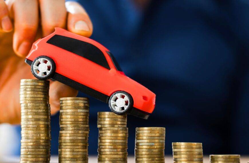 Toy car placed on stacked coins, representing gap insurance and vehicle value in case of theft