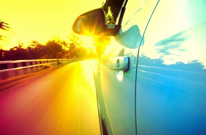 A car speeding down a road, highlighting the concept of insuring a vehicle you don't own