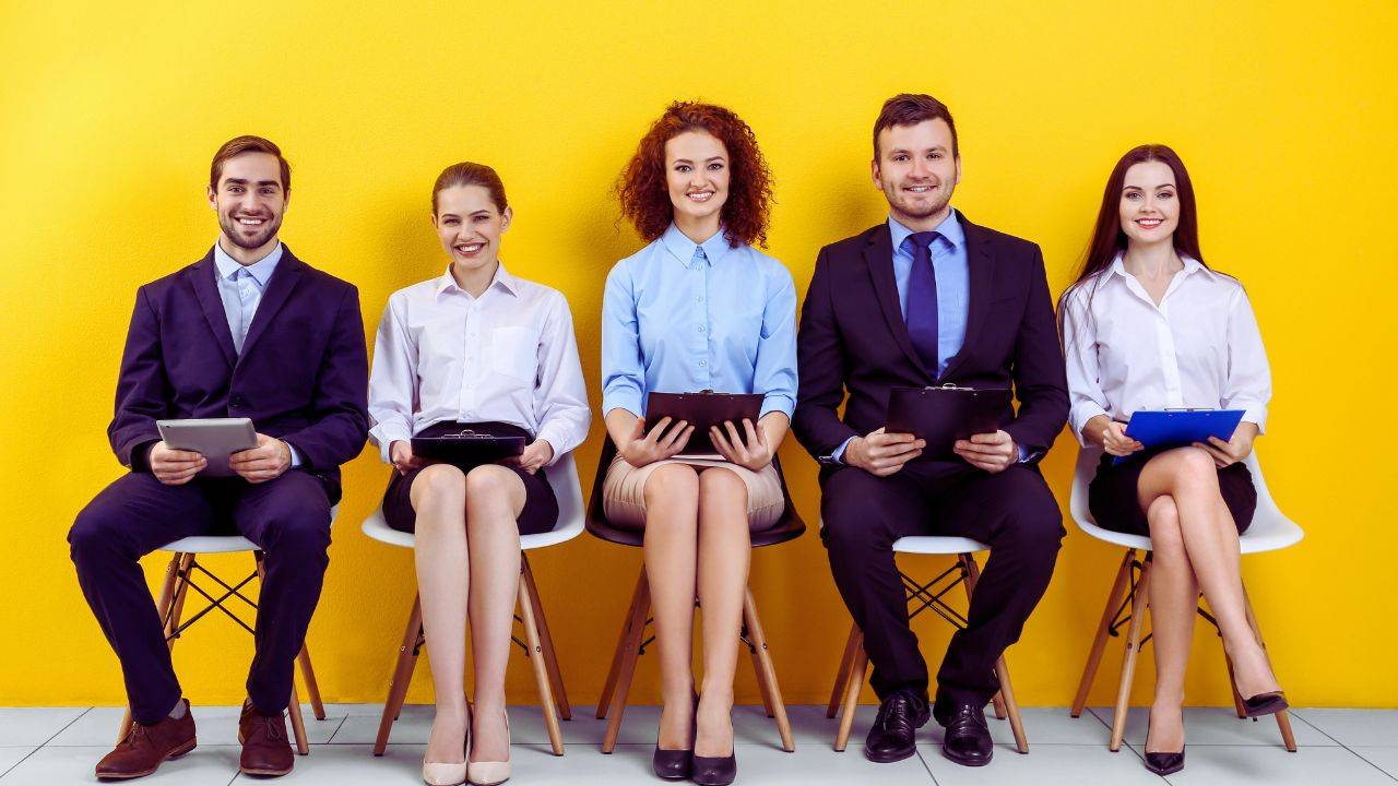 A group of diverse candidates seated, waiting for interviews, representing the future of job hiring in 2030