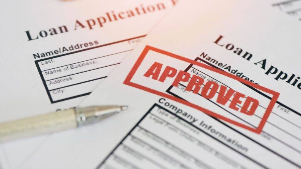 Loan application form with "Approved" stamp