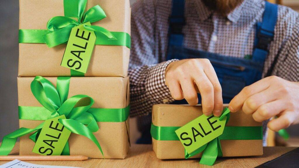 Person packaging items with sale tags, representing a successful dropshipping business