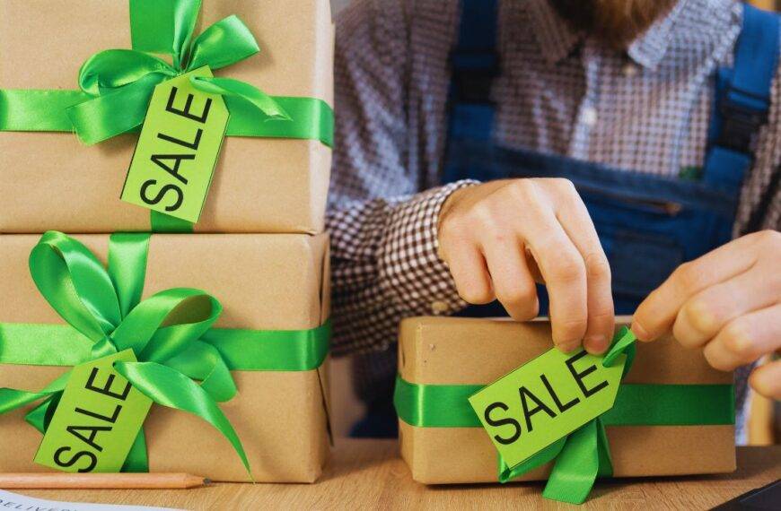 Person packaging items with sale tags, representing a successful dropshipping business