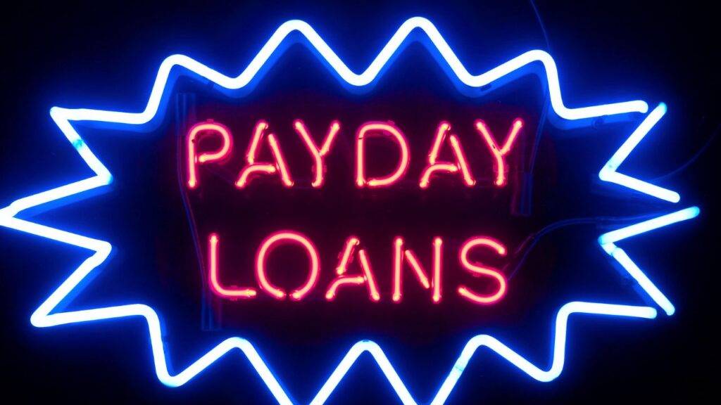 Neon sign displaying "Payday Loans," representing the concept of short-term, high-interest loans.