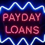 Neon sign displaying "Payday Loans," representing the concept of short-term, high-interest loans.